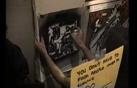 Stencil art going up at a WW3-related "Paint Jam" in 1990. 